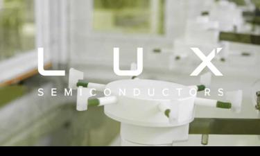 A photo of a working lab with "Lux Semiconductor" text atop the image in white 