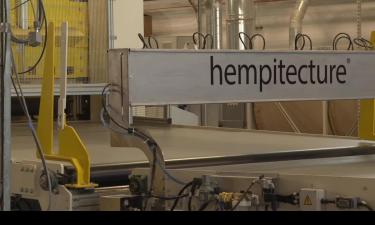 Equipment in an industrial building with a black text atop that says Hempitecture