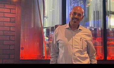 Harry Boston, founder of Boston Government Services, speaking passionately at the Innovation Crossroads Founders' Forum about his entrepreneurial journey and regional aspirations.